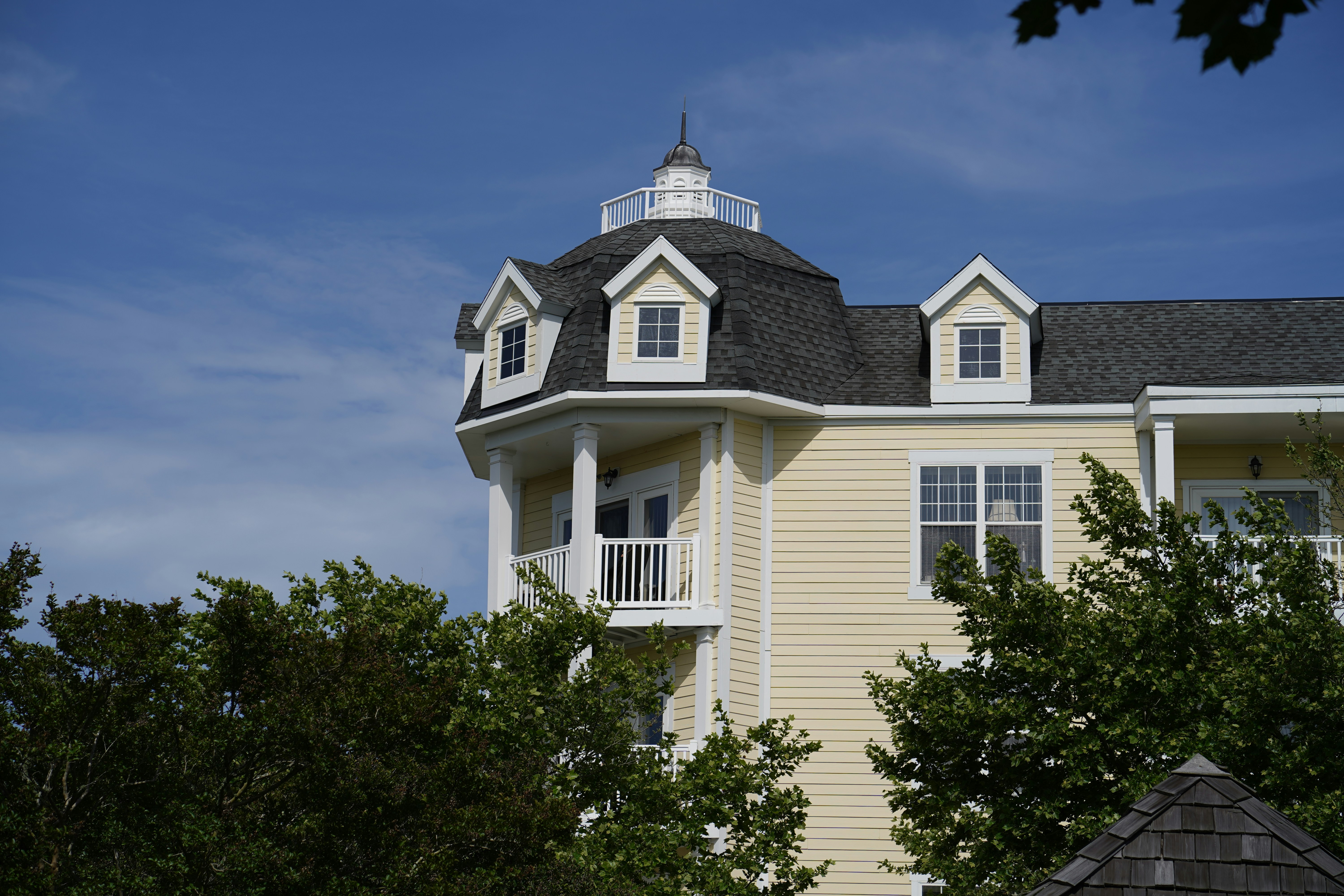 a large white house with a black roof