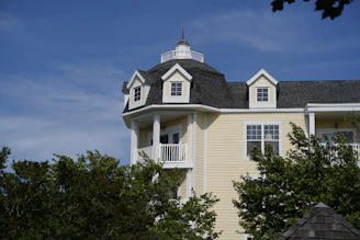 a large white house with a black roof