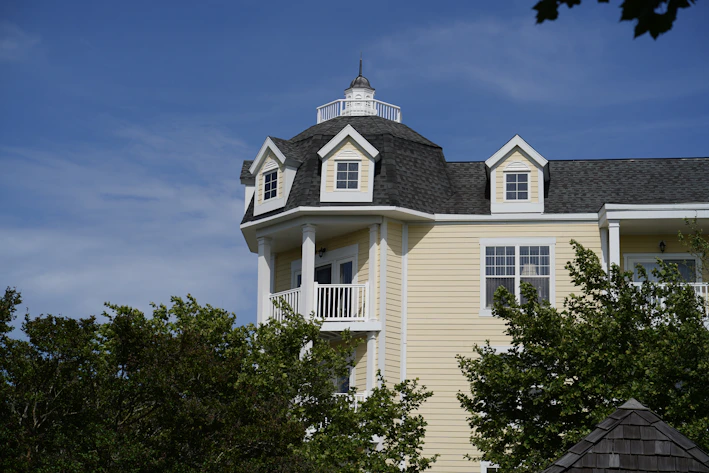 a large white house with a black roof