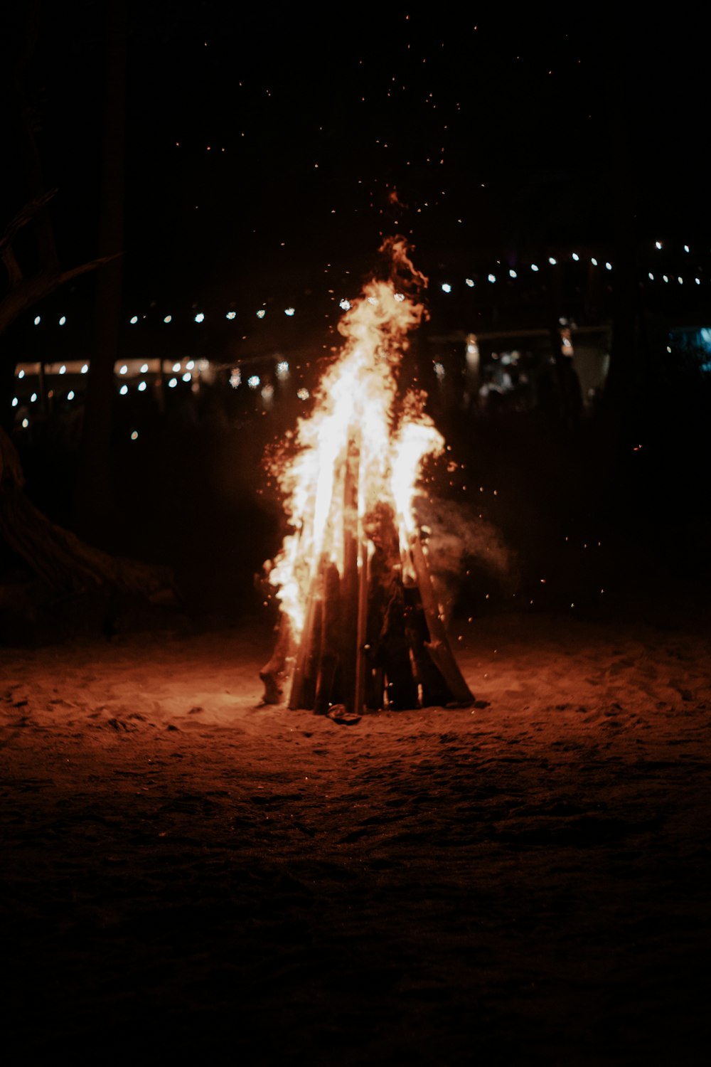 a bonfire is lit up in the dark