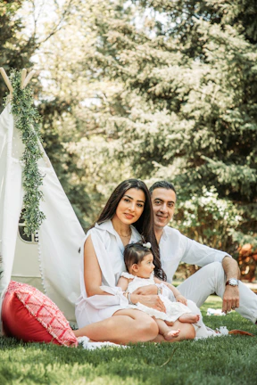 A family enjoying a camping trip with a spacious Touisset tent in the background.