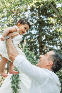 A joyful parent and baby sharing a moment while practicing sign language together.