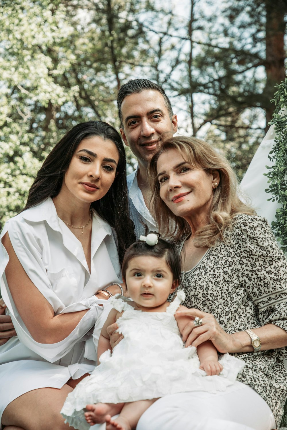 a family posing for a picture in the woods