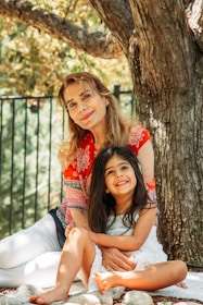 A warm scene of a mentor and teen girl sharing a heartfelt conversation outdoors.