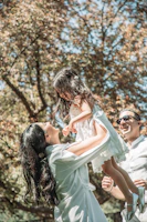 A joyful outdoor moment with families playing and connecting in a sunny park.