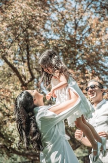 A joyful outdoor scene of a mom and her girls playing in the park, capturing movement and smiles.