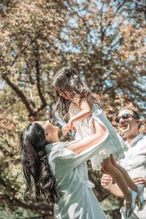 A joyful outdoor moment with families playing and connecting in a sunny park.