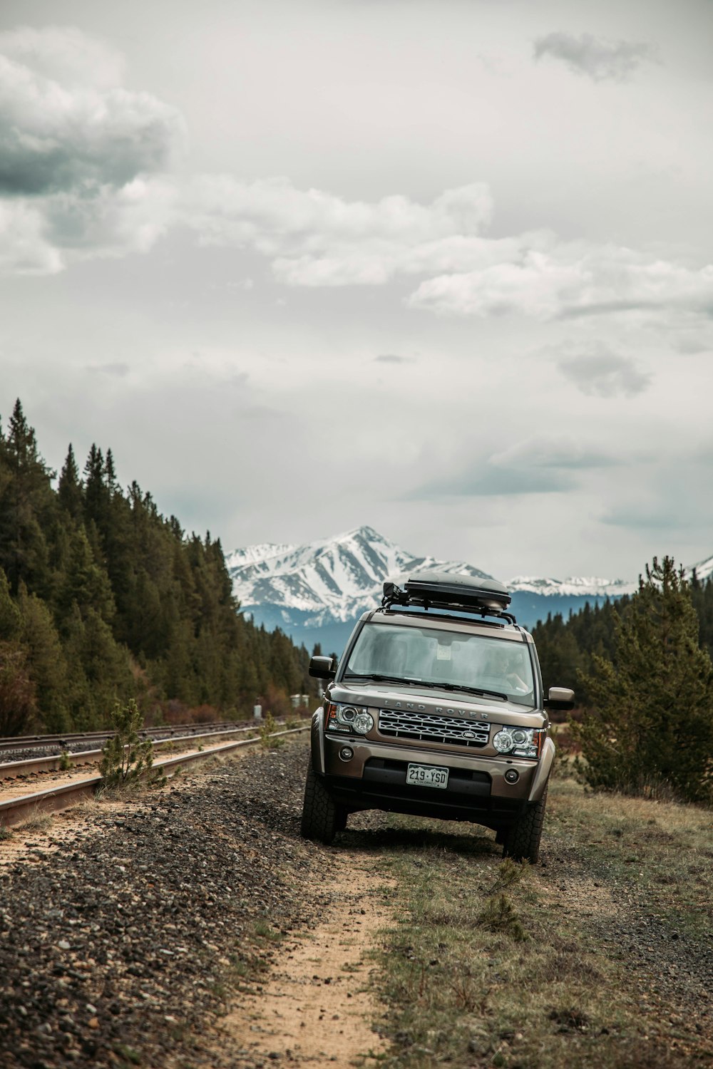 a car parked on the side of a dirt road