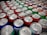 A refreshing assortment of colorful soda cans displayed on a wooden table.