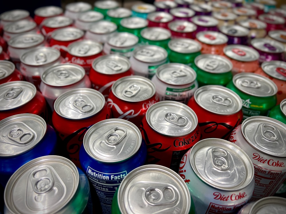 a large group of cans of soda