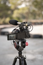a video camera on a tripod in a parking lot