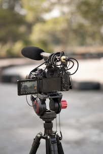 a video camera on a tripod in a parking lot