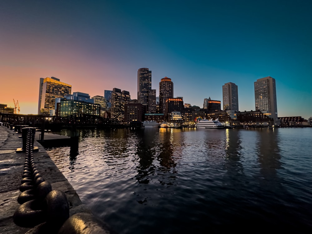 a view of a city from the water at sunset