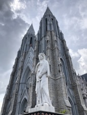 a large cathedral with a statue in front of it