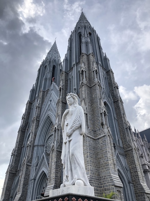 a large cathedral with a statue in front of it