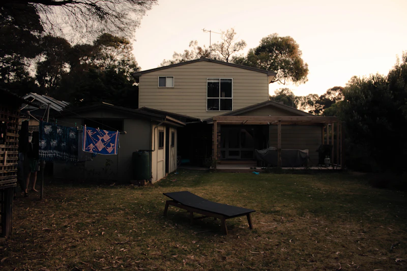 Backyard with bench and house in background