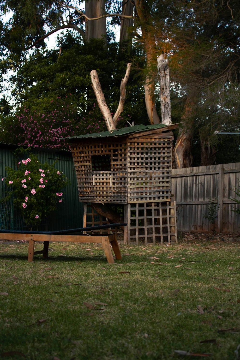 a wooden bench sitting in the middle of a yard