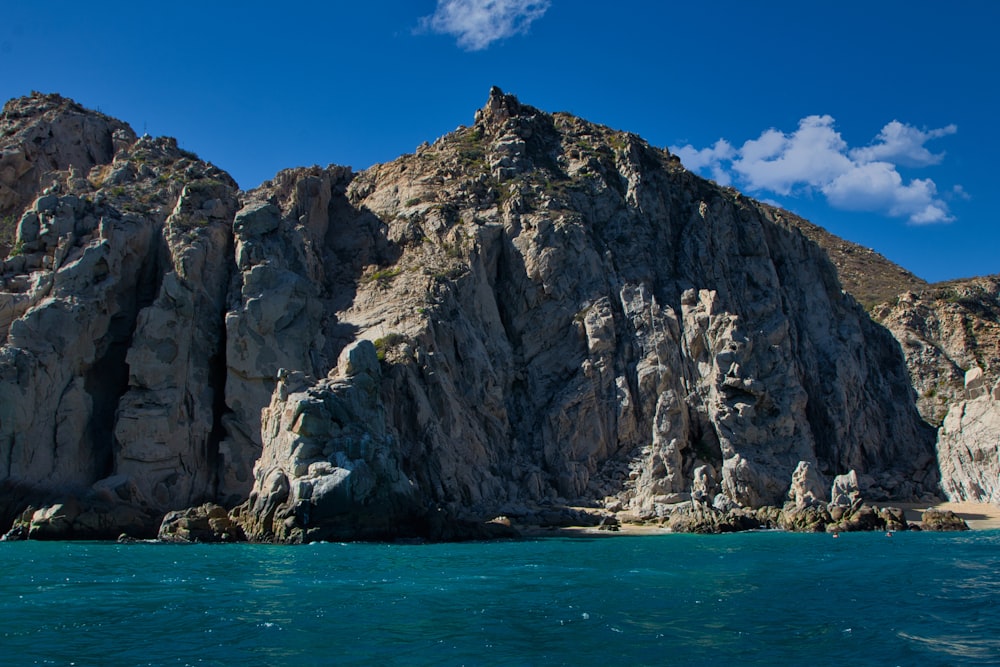 a large rock formation in the middle of a body of water