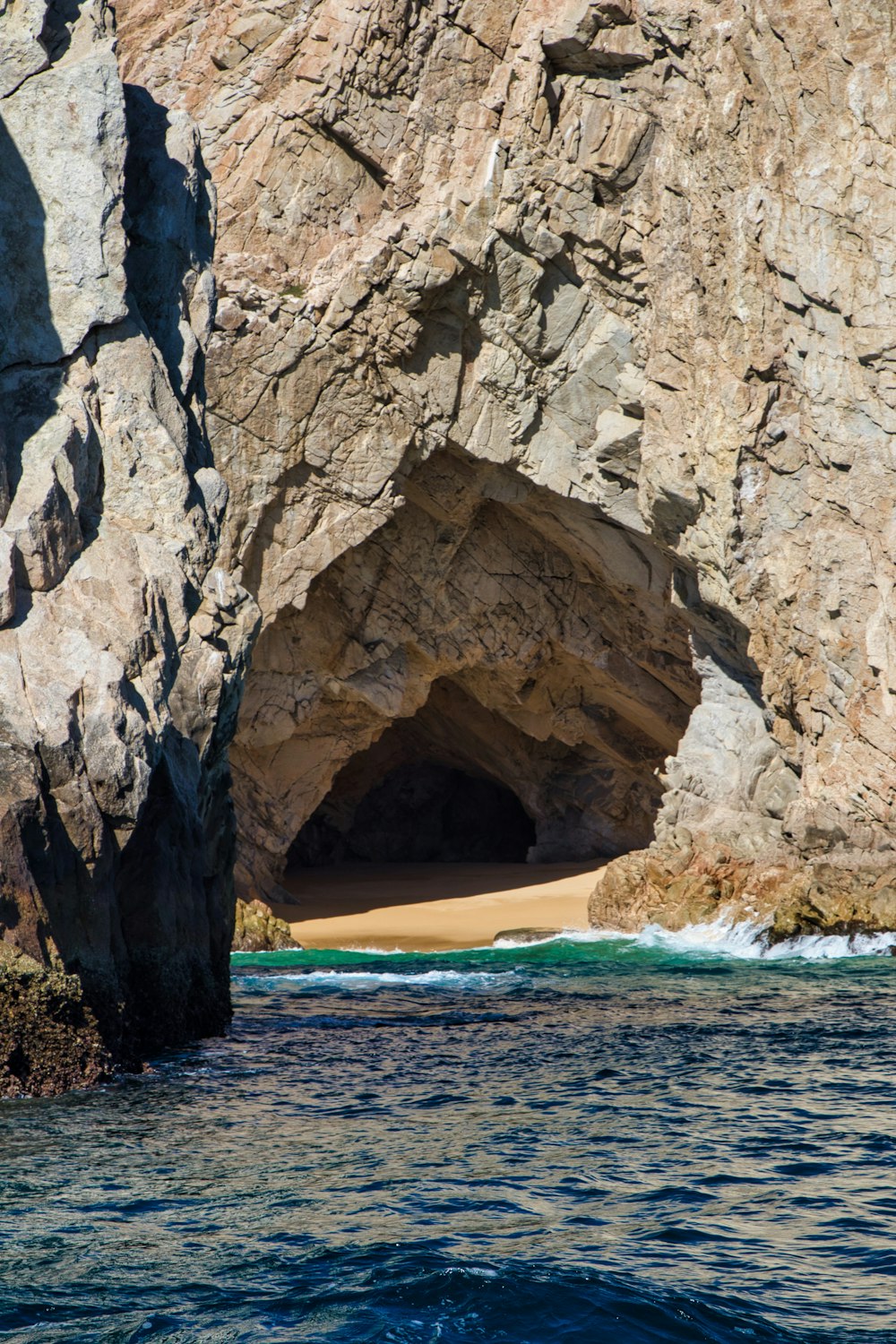 a large rock formation with a cave in the middle of it