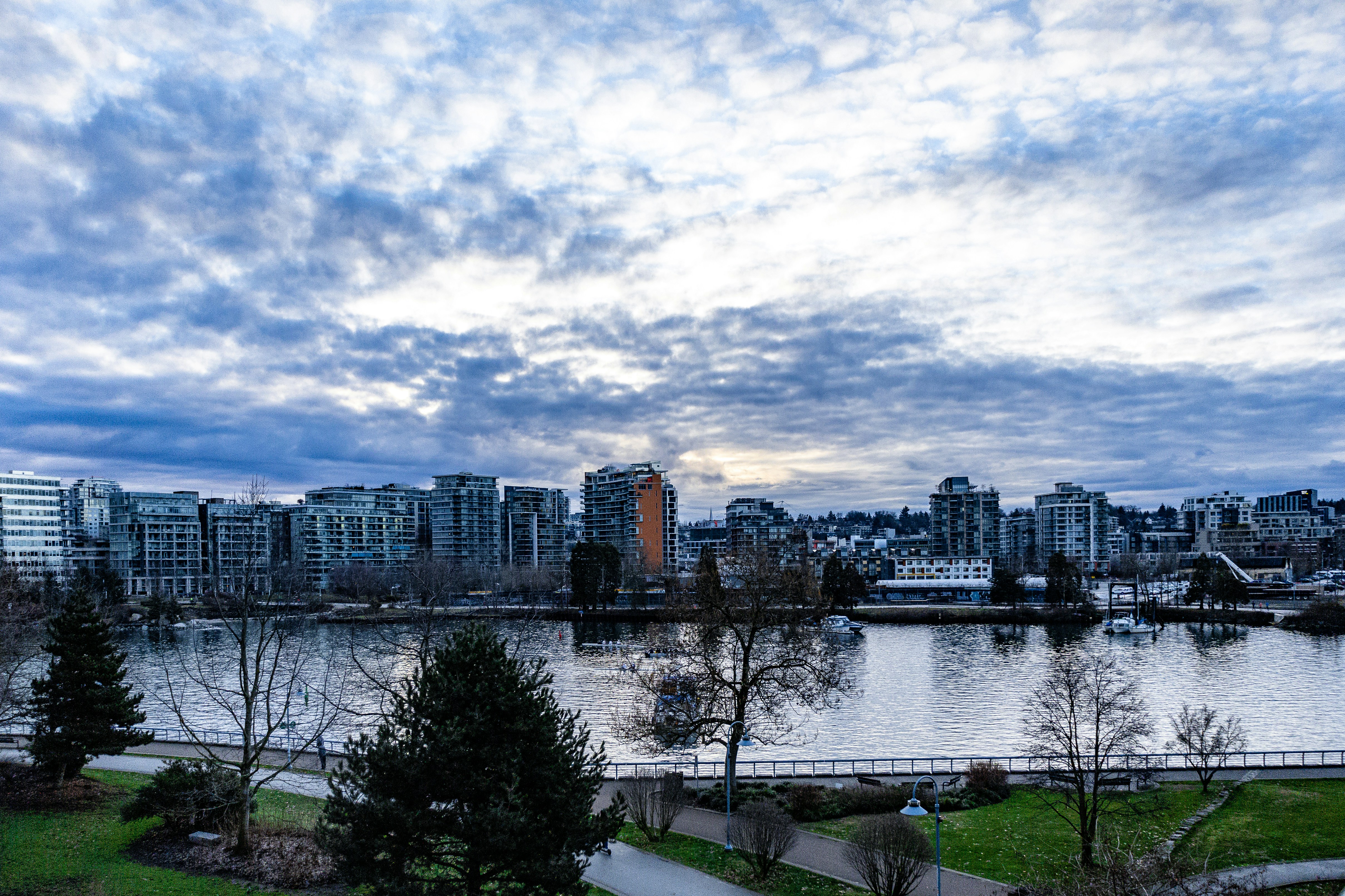 a view of a large body of water with a city in the background, 