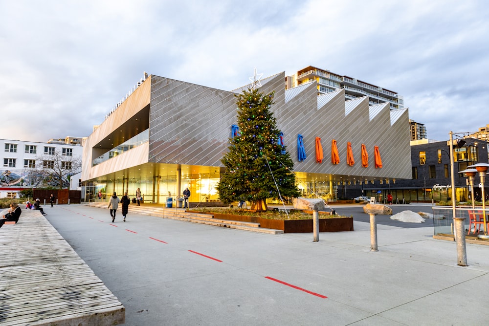 a large building with a christmas tree in front of it