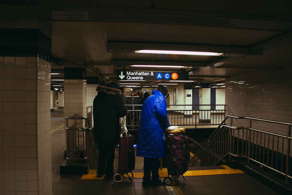 a group of people waiting at a subway station