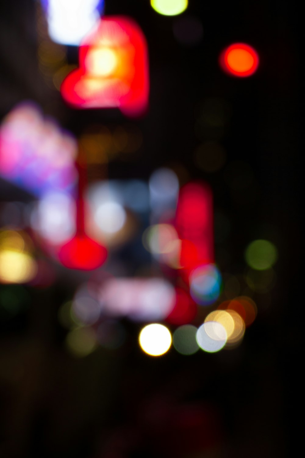 a blurry photo of a city street at night