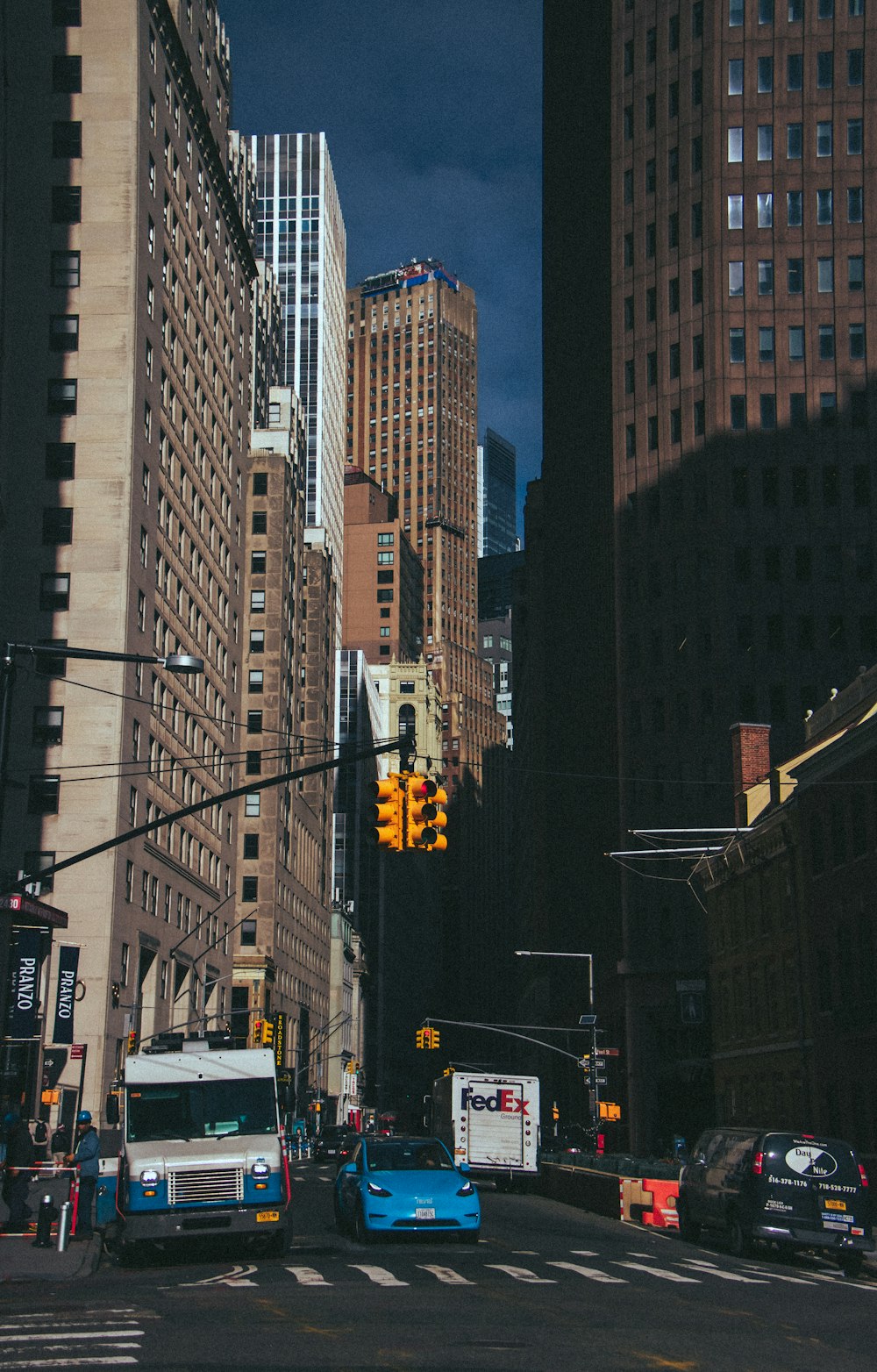 a city street filled with traffic and tall buildings