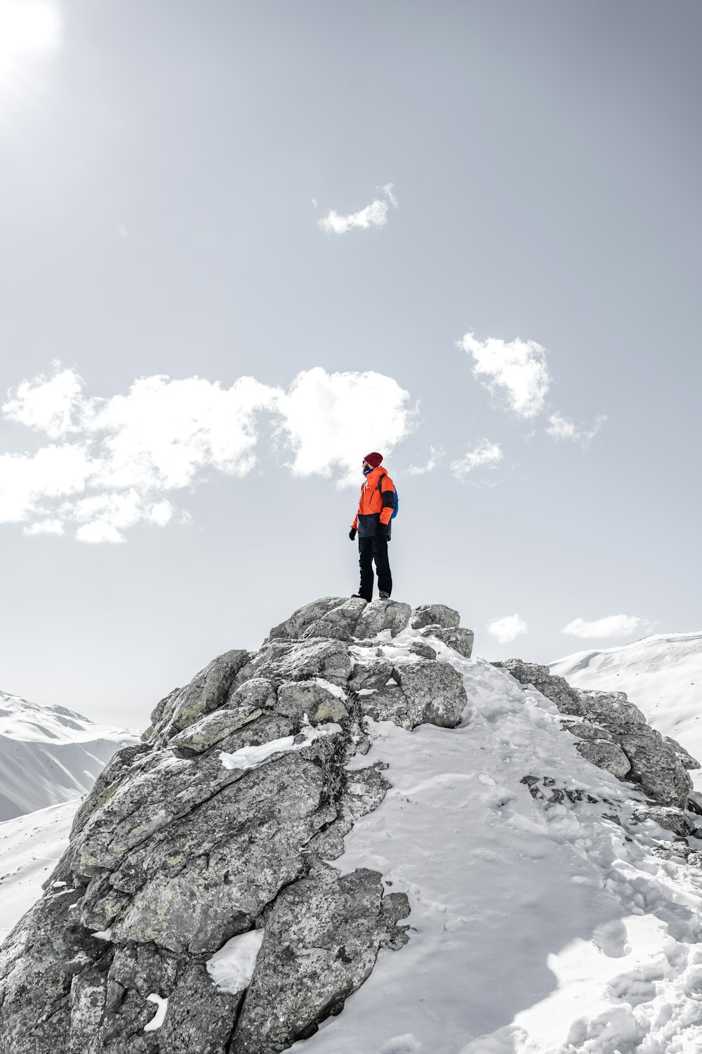 a man standing on top of a snow covered mountain