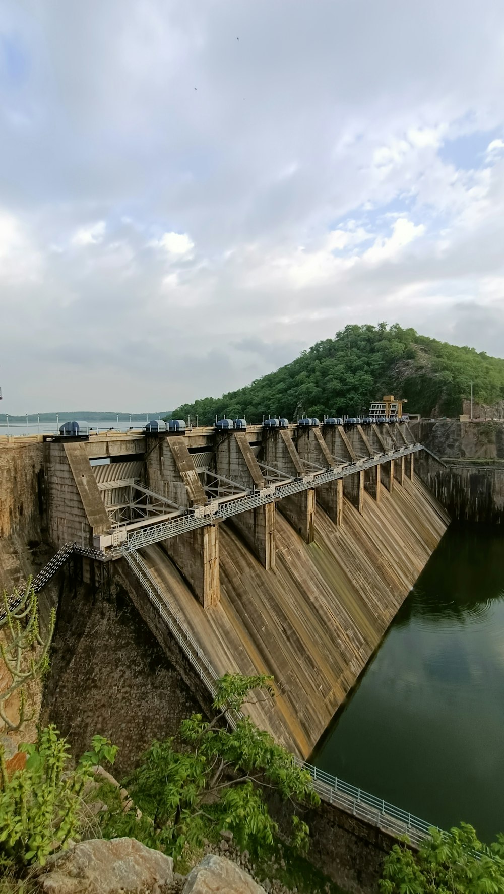 a large dam with a train on the side of it