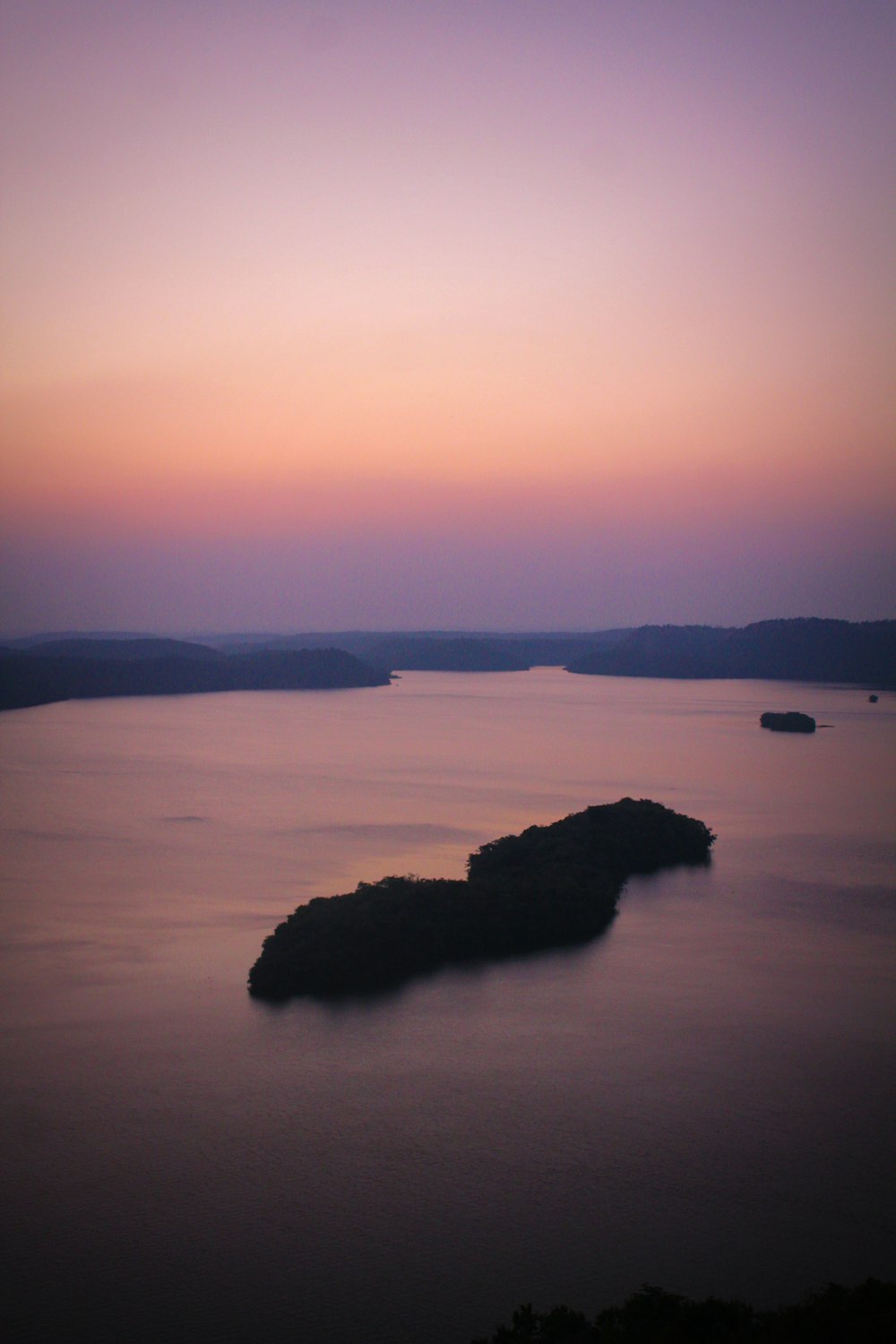 a body of water with a small island in the middle of it