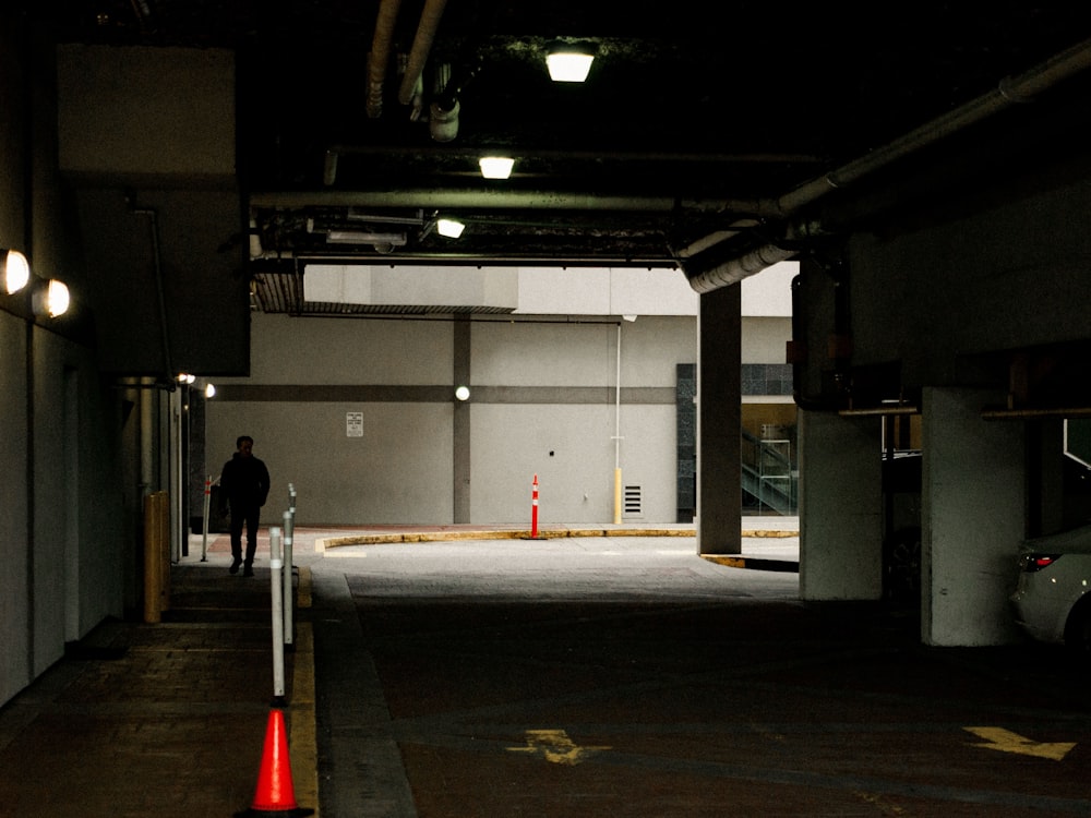 a person standing in a dark parking garage