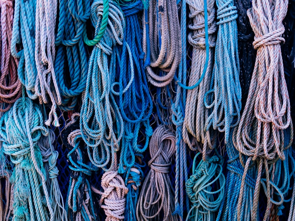 a bunch of ropes that are hanging on a wall