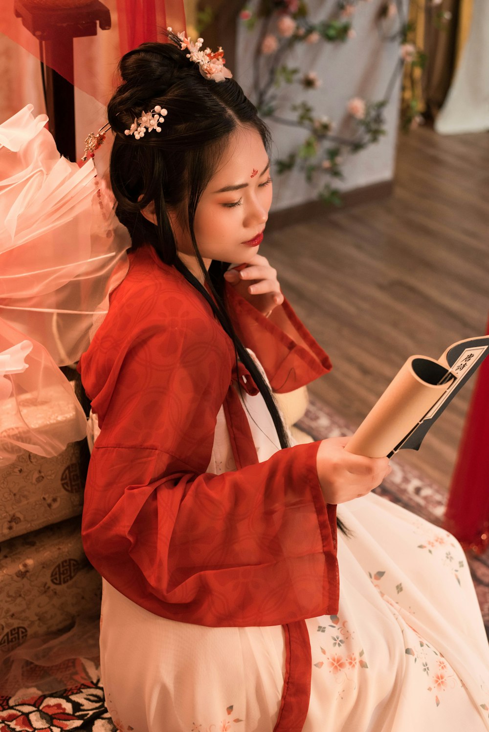a woman in a kimono reading a book