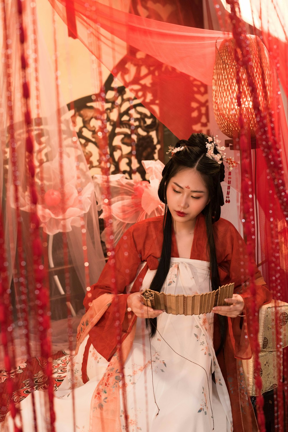 a woman in a white dress and a red jacket