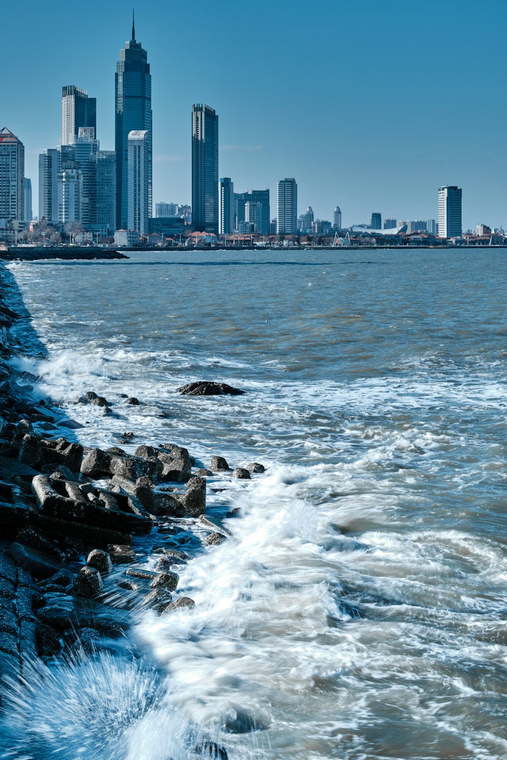 a body of water with a city in the background