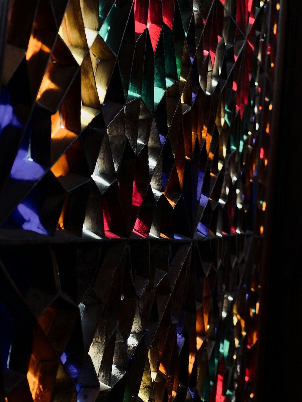 a colorful display of folded paper on a wall