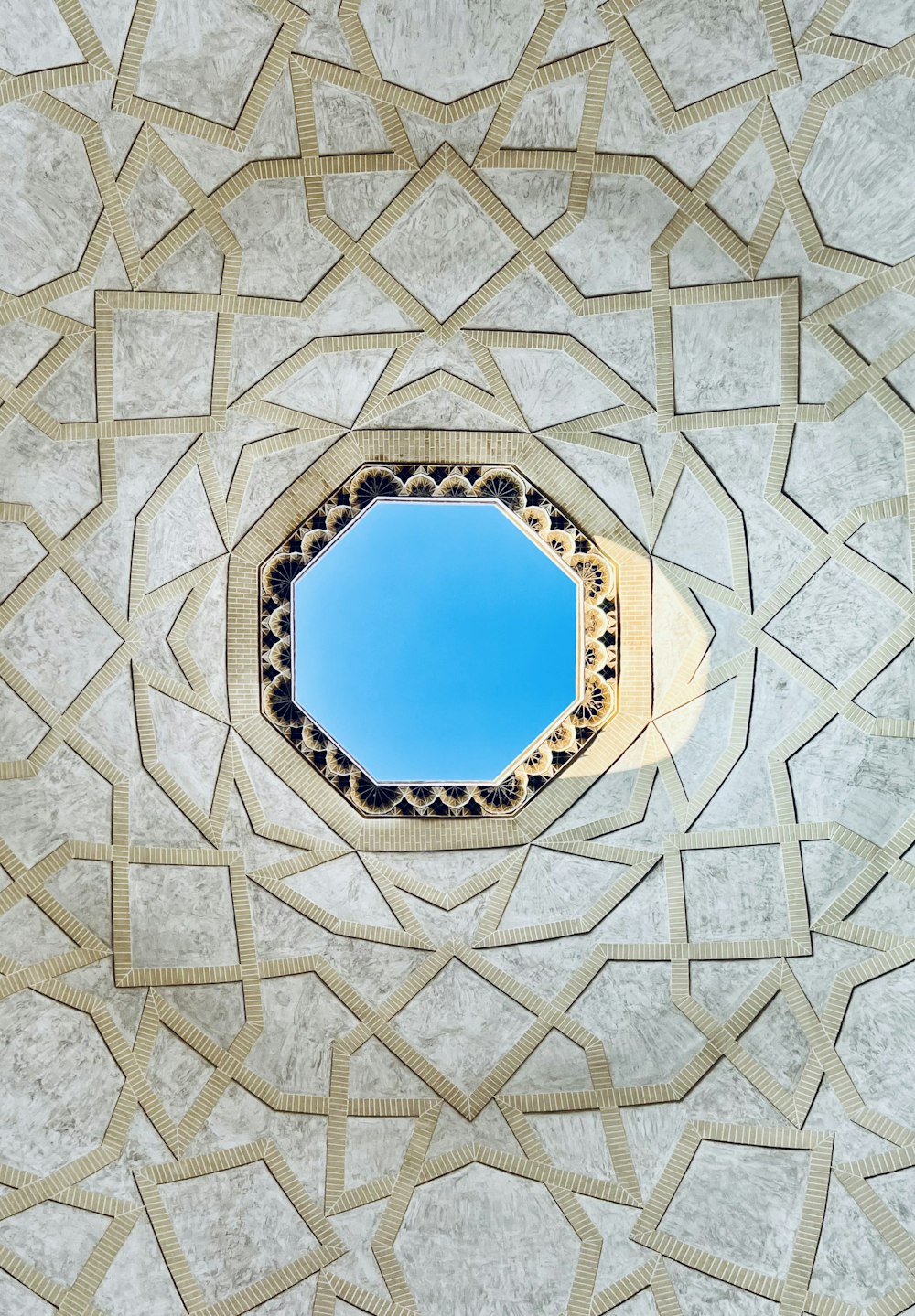 a blue sky is seen through a circular window