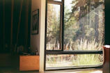 View of Savannah Suite room with warm natural light and wildlife scenery outside the window.
