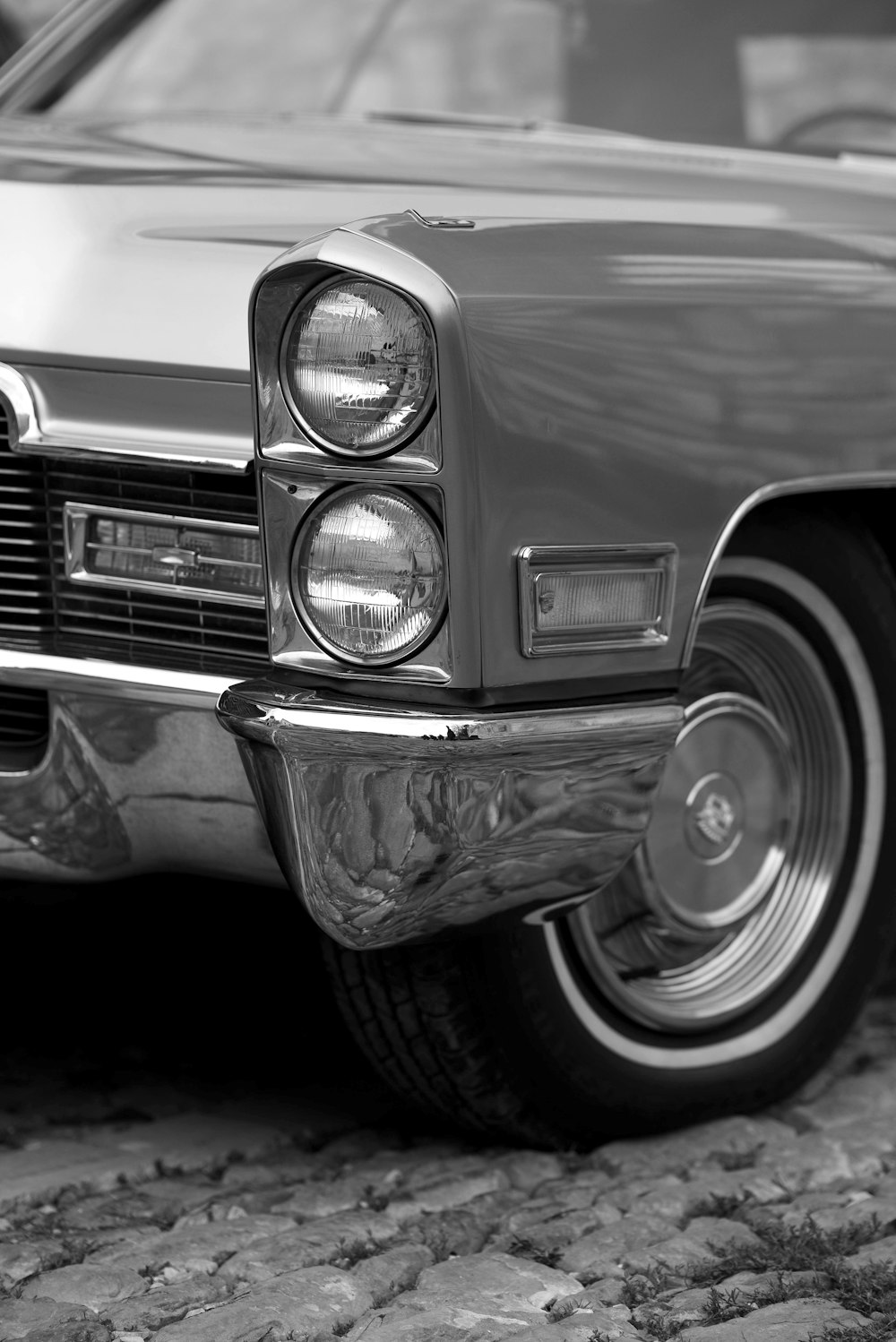 a black and white photo of a classic car