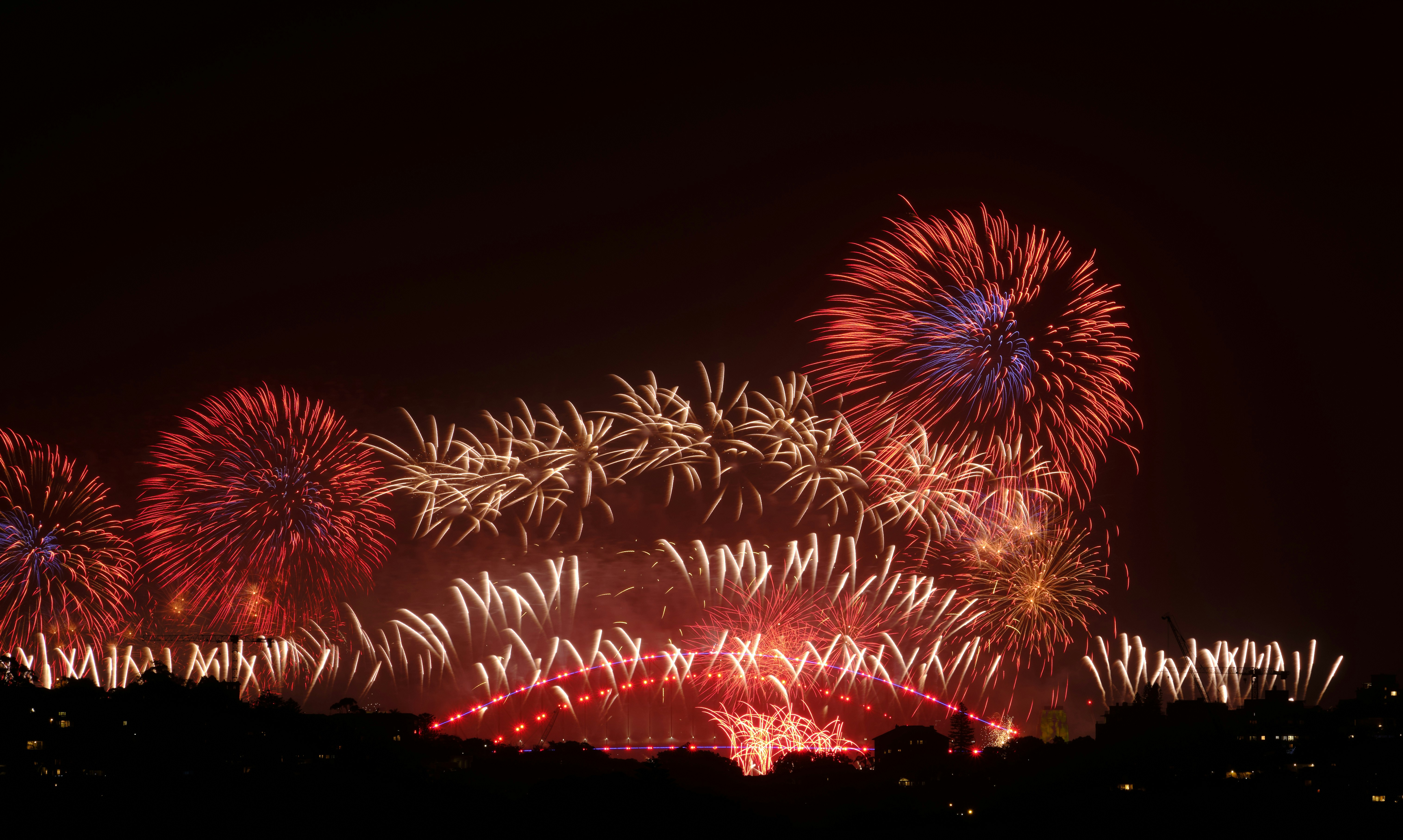 a bunch of fireworks are lit up in the night sky, 