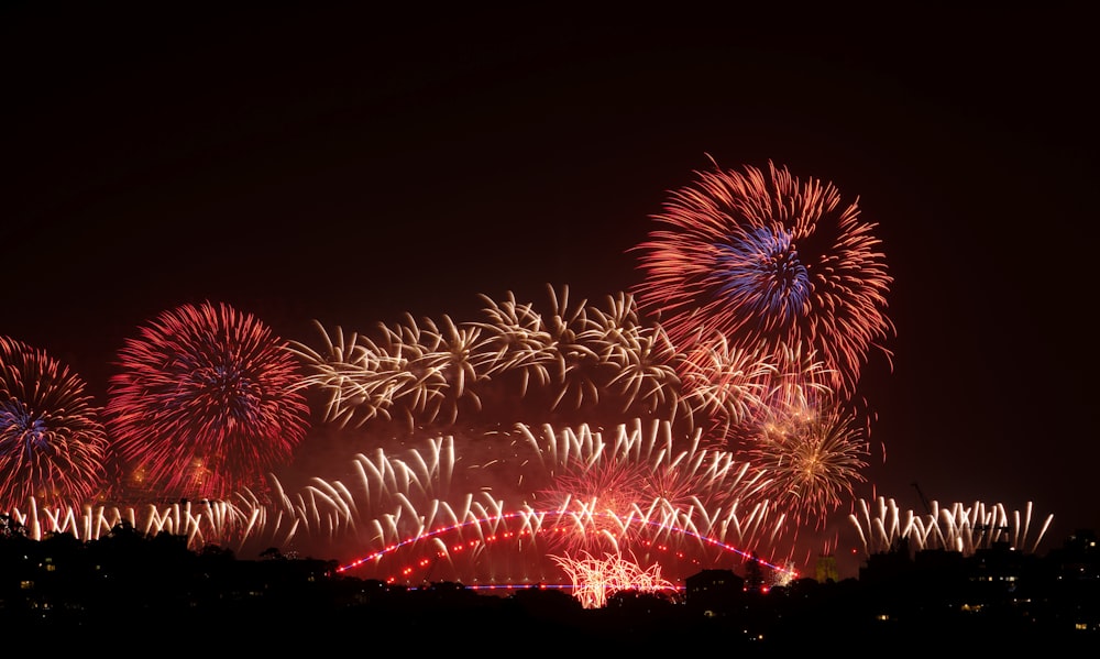 a bunch of fireworks are lit up in the night sky