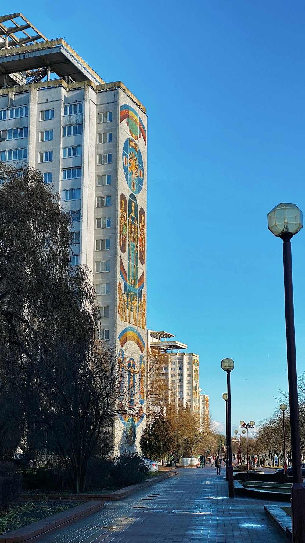 a city street with a tall building in the background