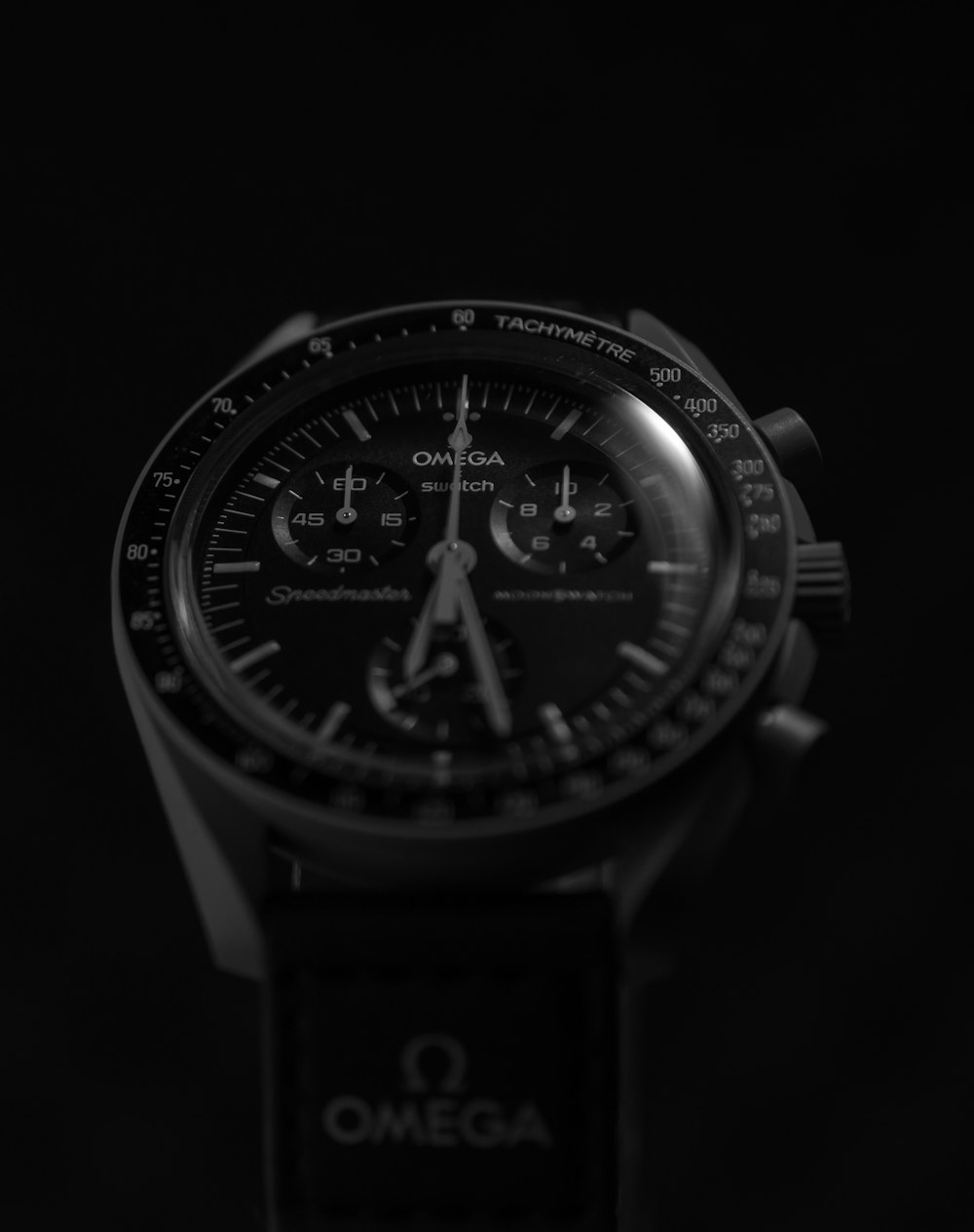 a close up of a watch on a black background