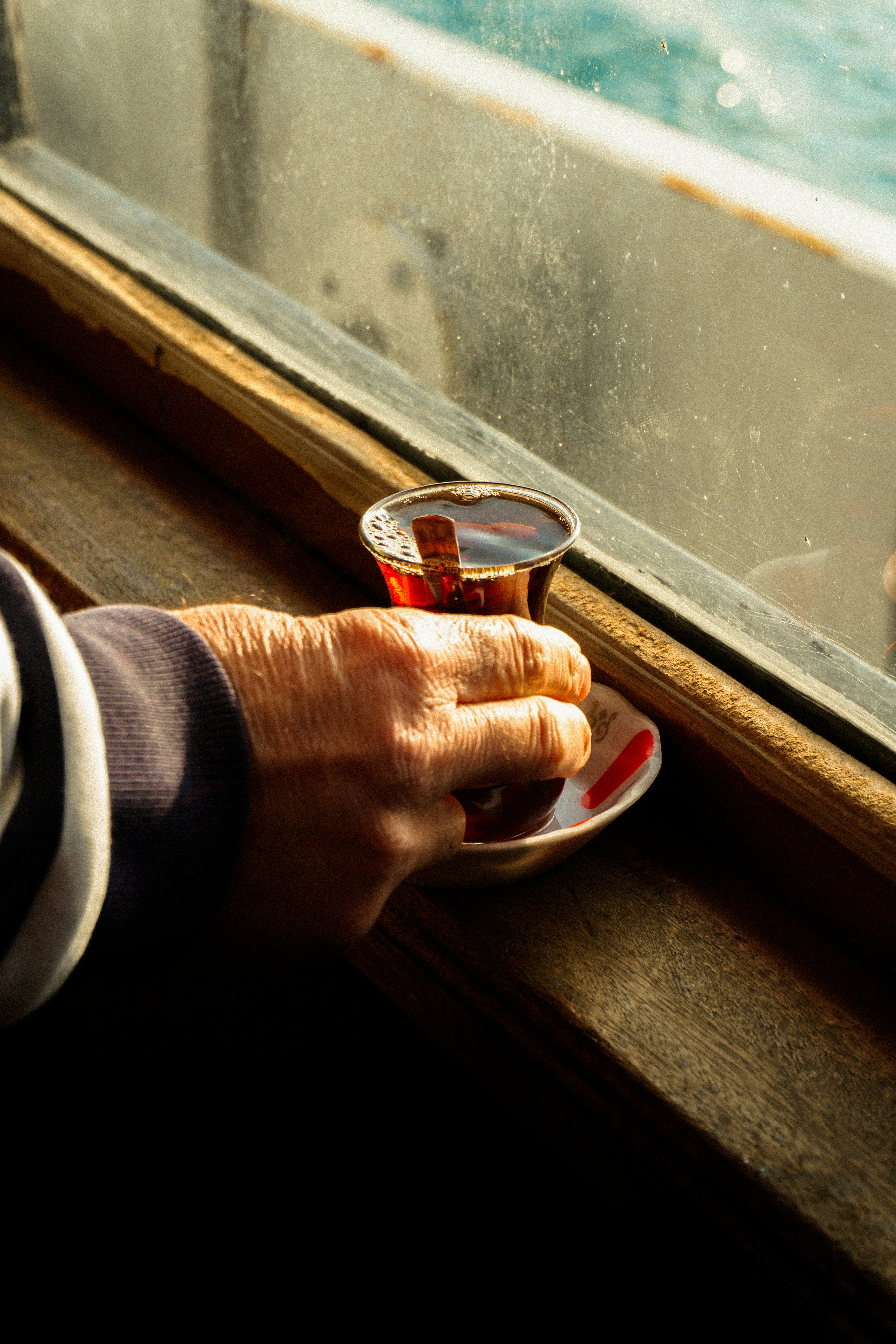 a person holding a cup of coffee on a plate