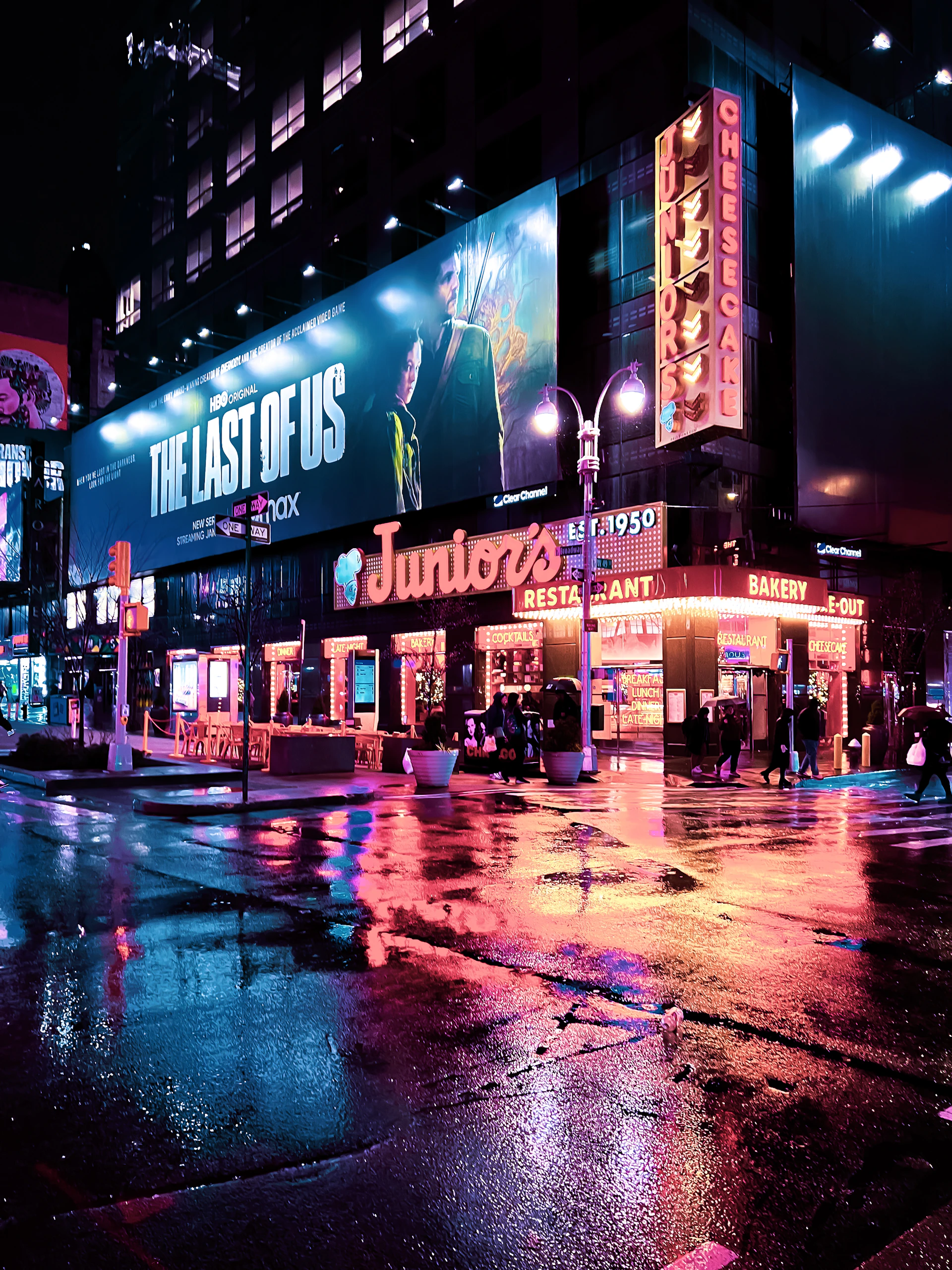 A dynamic screenshot from the GTA 6 trailer showing a bustling city street at night with neon lights and detailed character models.