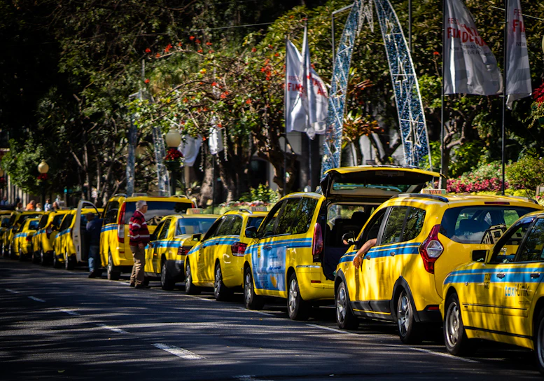 A vibrant city street with colorful taxis parked, ready for eager travelers.