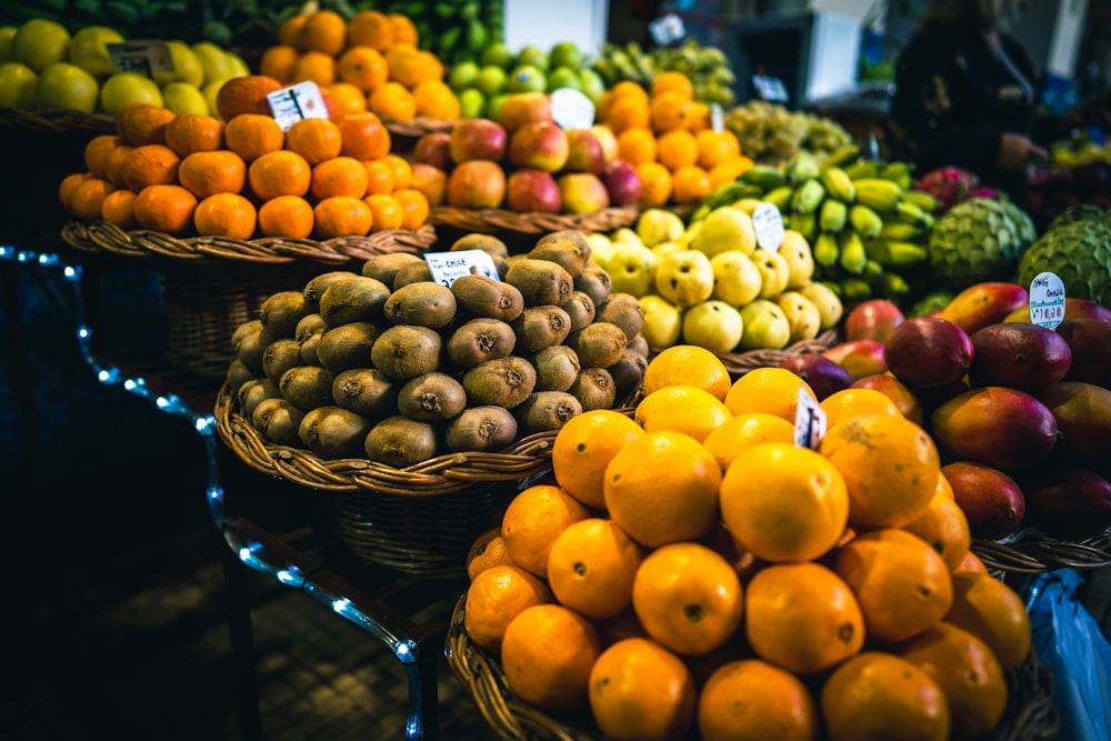 a bunch of baskets filled with different types of fruit