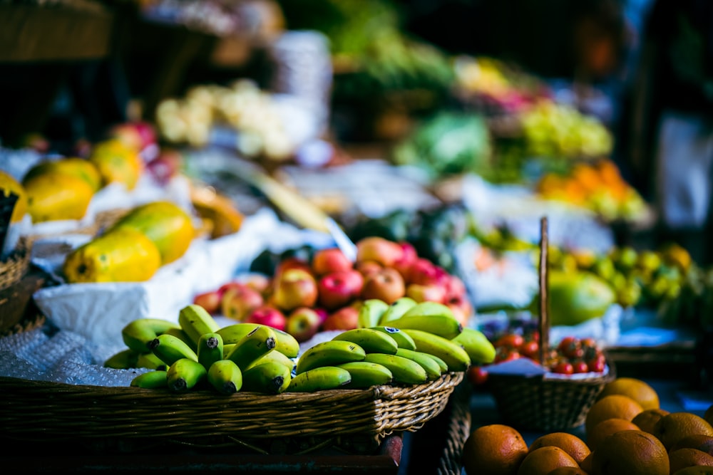 a bunch of baskets filled with different types of fruit