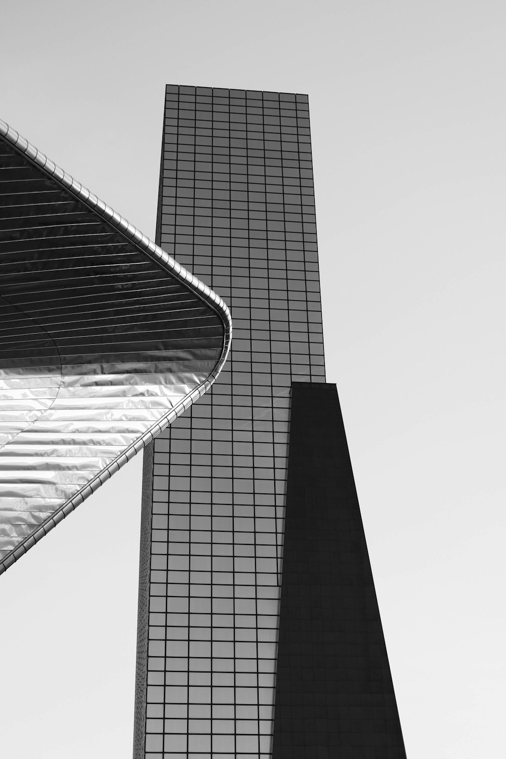 a black and white photo of two tall buildings